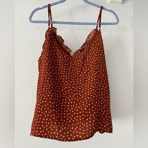 Dressy little tank top, rust colored with white spots. Ruffled neckline. Lined.